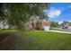Charming two-story brick home featuring an attached two car garage and a well-manicured lawn at 116 Holbrook Ln, Goose Creek, SC 29445