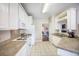 Well-lit kitchen with white cabinetry and appliances, and tile flooring at 116 Holbrook Ln, Goose Creek, SC 29445