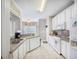 Bright kitchen features white cabinets, tile floors, and modern appliances at 116 Holbrook Ln, Goose Creek, SC 29445