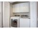 Bright laundry room featuring white appliances and ample cabinet space for organized storage solutions at 116 Holbrook Ln, Goose Creek, SC 29445