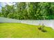 Private backyard with white fence and lush green grass provides space for relaxation and recreation at 124 Bright Meadow Rd, Summerville, SC 29483