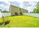 Grassy backyard with white privacy fence features ample space, ideal for outdoor entertaining at 124 Bright Meadow Rd, Summerville, SC 29483