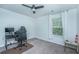 Home office setup in a bright, carpeted bedroom, featuring a gaming chair, and neutral tones at 124 Bright Meadow Rd, Summerville, SC 29483