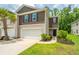 A well-maintained townhouse showcasing a two-car garage, manicured lawn, and appealing exterior finishes at 124 Bright Meadow Rd, Summerville, SC 29483