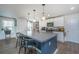 A contemporary kitchen island with bar stool seating and an open view of the living area at 124 Bright Meadow Rd, Summerville, SC 29483