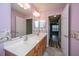 Bathroom featuring a double sink vanity, large mirror, and doorway to another room at 1304 Elm Hall Cir, Summerville, SC 29483