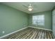 Bedroom with wood floors, ceiling fan, neutral green walls, and a bright window at 1304 Elm Hall Cir, Summerville, SC 29483