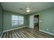 Bedroom featuring sleek floors, fan, a window and an open doorway leading to another room at 1304 Elm Hall Cir, Summerville, SC 29483