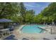 Community swimming pool surrounded by lounge chairs and mature trees, offering a relaxing and recreational space at 1304 Elm Hall Cir, Summerville, SC 29483