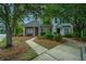 Inviting townhome exterior featuring a paved walkway, mature trees, and well-maintained landscaping at 1304 Elm Hall Cir, Summerville, SC 29483