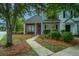 Charming two-story home with neutral siding, brick accents, a welcoming entrance, and mature landscaping at 1304 Elm Hall Cir, Summerville, SC 29483