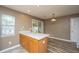 Kitchen island features granite countertop, wooden cabinets, and modern pendant lighting at 1304 Elm Hall Cir, Summerville, SC 29483