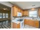 Charming kitchen with wooden cabinets, white appliances, granite countertops, and tiled backsplash at 1304 Elm Hall Cir, Summerville, SC 29483