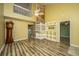 Spacious living room with soaring ceilings, distinctive wood floors, and open staircase at 1304 Elm Hall Cir, Summerville, SC 29483