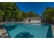 Community pool with clear blue water, deck chairs, and mature trees surrounding the property at 1304 Elm Hall Cir, Summerville, SC 29483