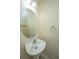 Powder room with pedestal sink, round mirror, and neutral wall color at 1304 Elm Hall Cir, Summerville, SC 29483
