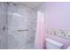Shower featuring a marble-look surround, a shower curtain, safety bar, and built in shelves at 1304 Elm Hall Cir, Summerville, SC 29483