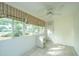 Bright sunroom with tile floor, large windows, and ceiling fan at 1304 Elm Hall Cir, Summerville, SC 29483