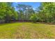 Exterior shot of a backyard with fresh green grass and mature shade trees on a clear day at 1320 Bresee St, Charleston, SC 29412