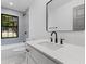 Updated bathroom featuring sleek vanity, modern fixtures, and stylish blue tile at 1320 Bresee St, Charleston, SC 29412