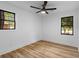 Bright bedroom with wood floors, two windows, and a ceiling fan at 1320 Bresee St, Charleston, SC 29412