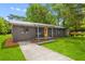 Charming single-story home with a well-manicured lawn, front porch, and bright yellow front door at 1320 Bresee St, Charleston, SC 29412
