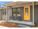 Inviting home exterior with a bright yellow door and charming front porch seating at 1320 Bresee St, Charleston, SC 29412