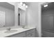 Bright bathroom featuring a double vanity with white countertops and modern fixtures at 135 Lilac Grove Way, Summerville, SC 29486
