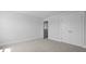 A bright bedroom featuring neutral walls, plush carpeting, and convenient closet space at 135 Lilac Grove Way, Summerville, SC 29486