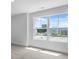 Sunlit bedroom view through large windows showcases the neighborhood and serene outdoor scenery at 135 Lilac Grove Way, Summerville, SC 29486