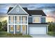 Charming two-story home featuring a front porch, attached garage, and blue siding at 135 Lilac Grove Way, Summerville, SC 29486