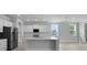 Well-lit kitchen with white cabinets, stainless steel refrigerator, and center island at 135 Lilac Grove Way, Summerville, SC 29486