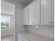 Kitchen pantry cabinets with quartz countertops and white subway tile backsplash at 135 Lilac Grove Way, Summerville, SC 29486