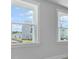 Large windows offer views of the neighborhood, adding natural light to the space at 135 Lilac Grove Way, Summerville, SC 29486