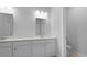 Well-lit bathroom showcases a double vanity with white cabinets, countertop, and a neatly framed mirror at 139 Lilac Grove Way, Summerville, SC 29486