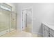 Bright bathroom boasts a tiled glass shower, light-toned tile floor, and a doorway that provides seamless flow at 139 Lilac Grove Way, Summerville, SC 29486