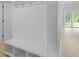 Modern entryway featuring a built-in bench with storage and hooks, and a view to the backyard at 139 Lilac Grove Way, Summerville, SC 29486