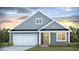 Charming blue two-story home with a manicured lawn and an attached garage at 139 Lilac Grove Way, Summerville, SC 29486