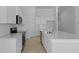 Modern kitchen with white cabinets, a tile backsplash, stainless steel appliances, and a center island at 139 Lilac Grove Way, Summerville, SC 29486