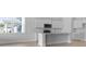 White kitchen with stainless steel appliances, a stylish island, and bright natural light at 139 Lilac Grove Way, Summerville, SC 29486