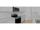 Well-equipped kitchen with stainless steel microwave, a tiled backsplash, and white cabinetry at 139 Lilac Grove Way, Summerville, SC 29486