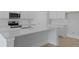 Bright kitchen features a large quartz countertop island, stainless steel appliances, and white cabinetry at 139 Lilac Grove Way, Summerville, SC 29486