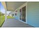 Covered outdoor patio features a sliding glass door for easy access to the interior and a calming exterior paint at 139 Lilac Grove Way, Summerville, SC 29486