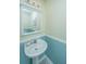 Charming half-bathroom featuring a pedestal sink, framed mirror, and decorative lighting at 1401 Elm Hall Cir, Summerville, SC 29483