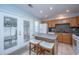 Well-lit kitchen with a center island, tile floors, wooden cabinets, and modern appliances at 1401 Elm Hall Cir, Summerville, SC 29483