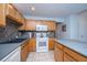 Functional kitchen with wooden cabinets, a center island, tile flooring, and stainless steel appliances at 1401 Elm Hall Cir, Summerville, SC 29483