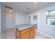 Well-lit kitchen with an island, tile floor and access to the patio via glass paneled doors at 1401 Elm Hall Cir, Summerville, SC 29483