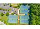 Aerial view showcases tennis courts, a clubhouse, and parking nestled in a well-maintained neighborhood setting at 1409 Bloomingdale Ln, Mount Pleasant, SC 29466