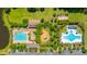 Aerial view shows a large pool, playground, and small pool within a beautiful and well-maintained planned community at 1409 Bloomingdale Ln, Mount Pleasant, SC 29466