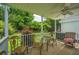 This back porch features a white ceiling fan and a table and chairs for entertaining guests at 1409 Bloomingdale Ln, Mount Pleasant, SC 29466